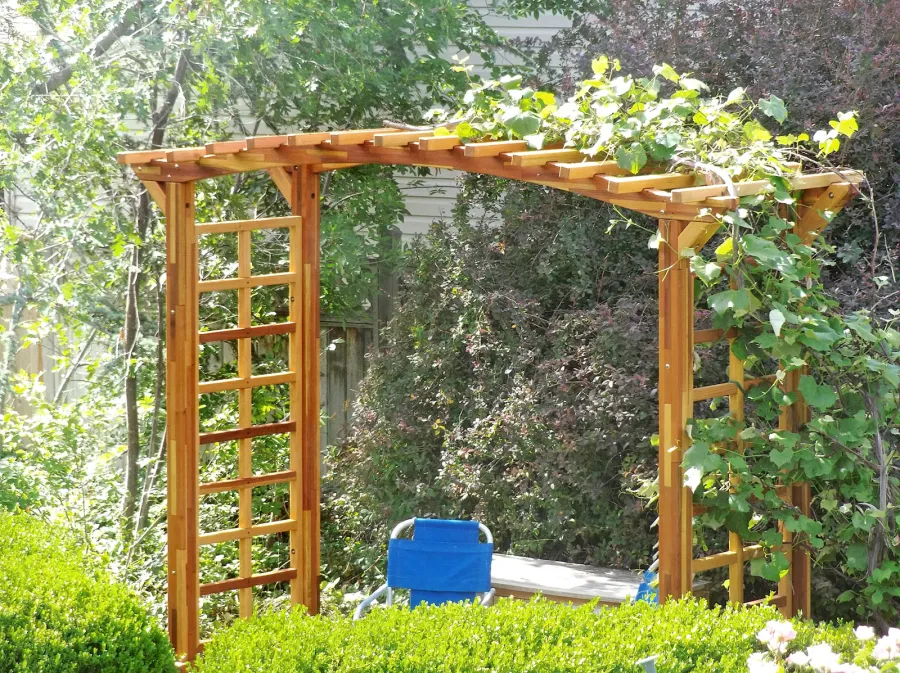 Arched Garden Arbor (Options: 108" W x Custom 48" D, Mosaic Redwood, 4-Post Kit for Concrete, Transparent Premium Sealant). Photo Courtesy of B. Ellis of Salt Lake City, Utah.