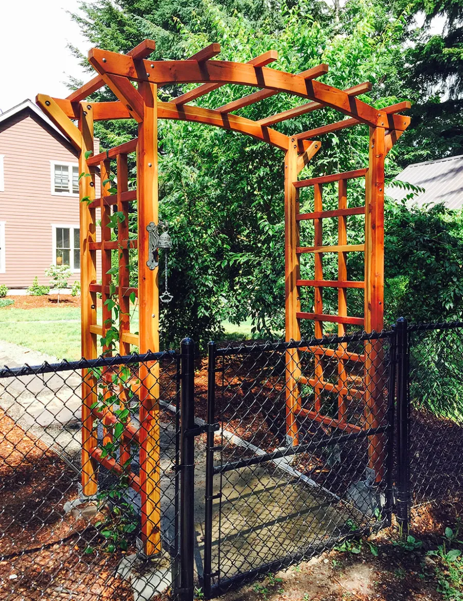Arched Garden Arbor (Options: 60" W x 36" D, California Redwood, No Anchor Kit, Transparent Premium Sealant). Photo Courtesy of Evelyn and Dan Martin of Poulsbo, Washington.