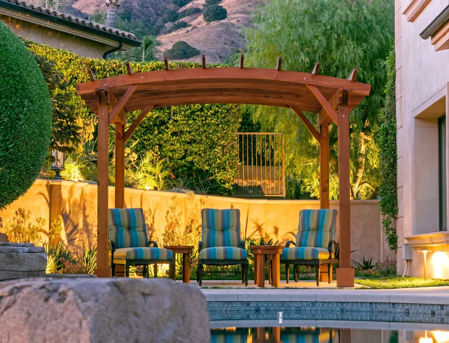 Arched Open Sky PergolaArched Open Sky Pergolas (Options: 11' L x 13' Arc W, Mature Redwood, Unattached, No Electrical Wiring Trim, 4-Post Anchor Kit for Concrete, No Ceiling Fan Base, No Privacy Panels, No Curtain Rods, 9' Post Height, Transparent Premium Sealant). Photo courtesy of G. Gigante of Glendora, CA.
