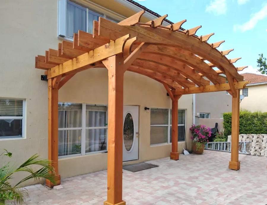 Custom Arched Open Sky Pergolas (Options: Douglas-fir, 10' H Posts, 4-Post Anchor Kit for High-Wind, Transparent Premium Sealant). Shows custom wall anchor customization to attach to home (can be added upon request).