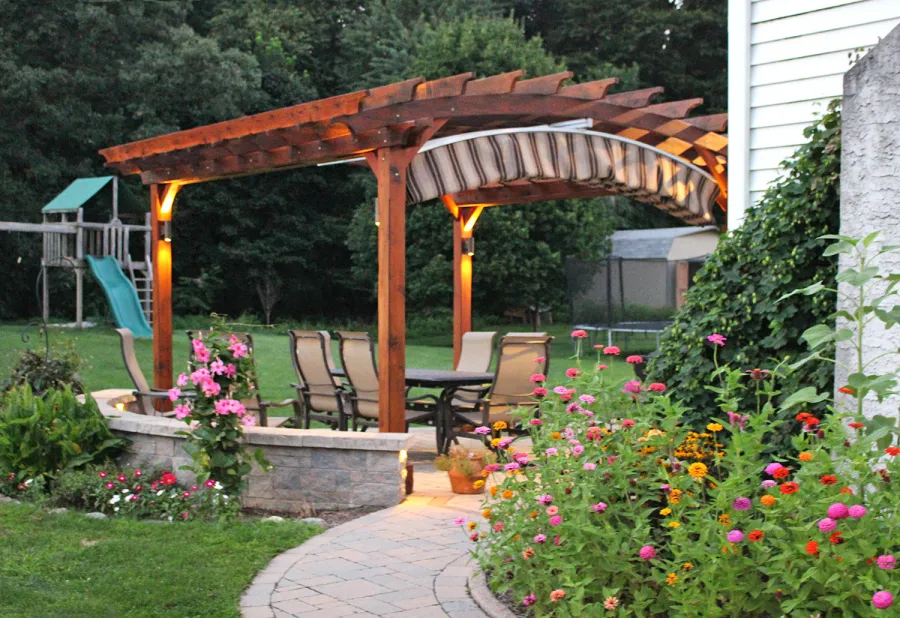Arched Open Sky Pergolas (Options: 14' L x 14' Arc W, California Redwood, Unattached, Electrical Wiring Trim for 2 Posts, Arched Roof without Lattice Panels, 4-Post Anchor Kit for Concrete, No Ceiling Fan Base, No Privacy Panels, No Curtain Rods, 9' Post Height, Transparent Premium Sealant). 18" Overhang of Arches. Ends of arches with Same Roosevelt End Detail Work as Have the Supports and Slats. Pergola Installed in 2014. Photo Courtesy of J. Martin of Morgantown, Pennsylvania.