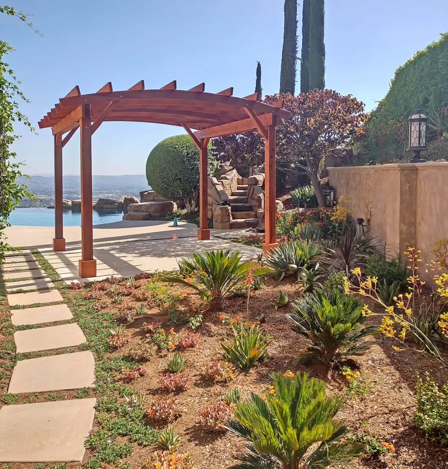 Arched Open Sky Pergolas (Options: 11' L x 13' Arc W, Mature Redwood, Unattached, No Electrical Wiring Trim, 4-Post Anchor Kit for Concrete, No Ceiling Fan Base, No Privacy Panels, No Curtain Rods, 9' Post Height, Transparent Premium Sealant). Photo courtesy of G. Gigante of Glendora, CA.