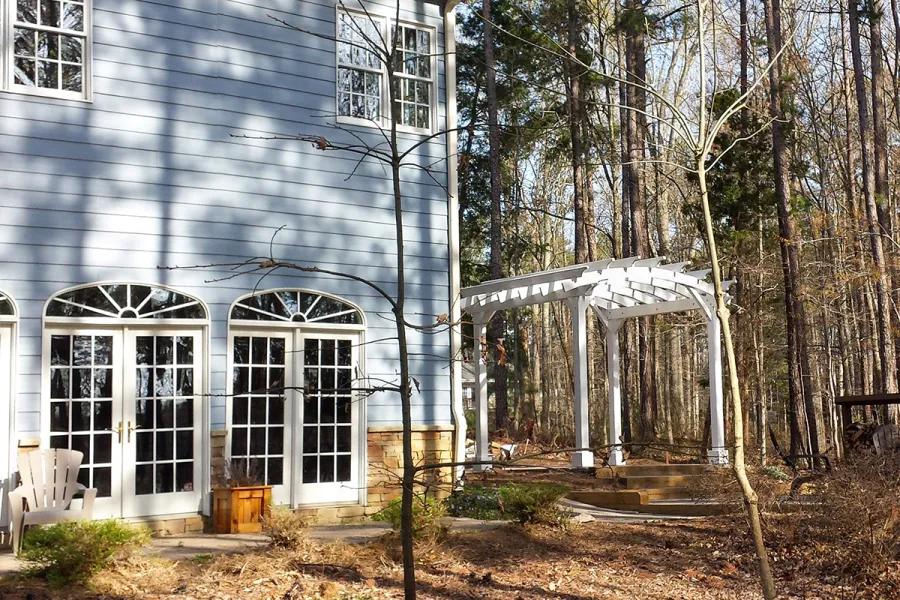 Arched Open Sky Pergolas (Options: 10' L x 12' Arc W, Douglas-fir, Unattached, No Electrical Wiring Trim, Arched Roof without Lattice Panels, 4-Post Anchor Kit for Stone, No Ceiling Fan Base, No Privacy Panels, No Curtain Rods, 9' Post Height, Off-White Oil-Based Primer). Photo courtesy of D. Bochnovic of Henderson, North Carolina.