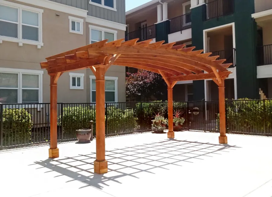 Arched Open Sky Pergolas (Options: 10' L x 20' Arc W, California Redwood, No Electrical Wiring Trim, Horizontal Decorative Trims on Posts, 4-Post Anchor Kit for Concrete, No Ceiling Fan Base, No Privacy Panels, No Curtain Rods, 9' Post Height, Transparent Premium Sealant). Photo Courtesy of M. Castaneda of Pleasanton, CA.