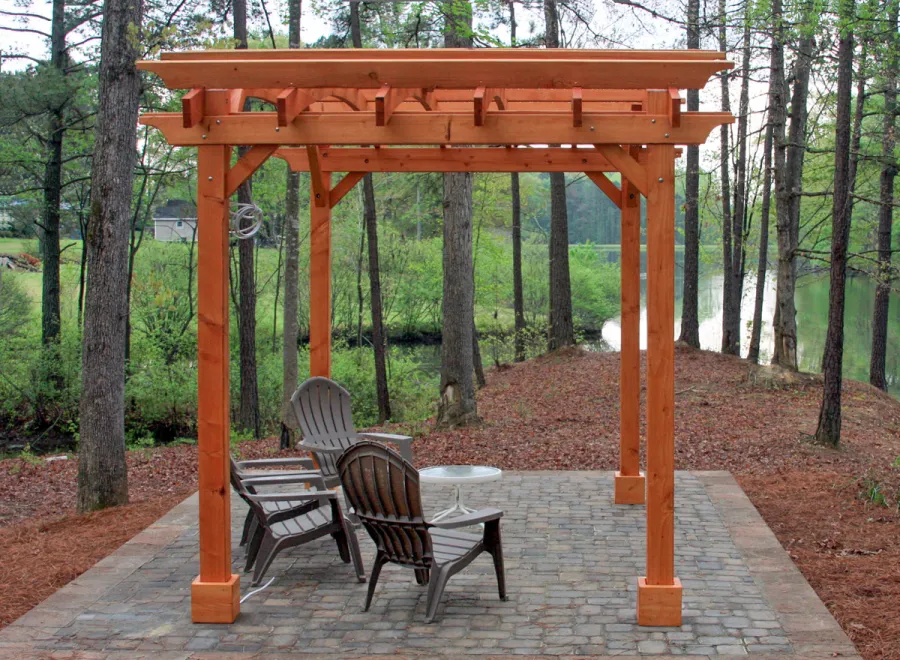 Arched Open Sky Pergolas (Options: 10' L x 14' Arc W, Mature Redwood, Unattached, No Electrical Wiring Trim, Arched Roof without Lattice Panels, 4-Post Anchor Kit for Stone, With Ceiling Fan Base, No Privacy Panels, No Curtain Rods, 9' Post Height, Transparent Premium Sealant). Photo Courtesy of Randall & Florence W. of Willow Spring, North Carolina.