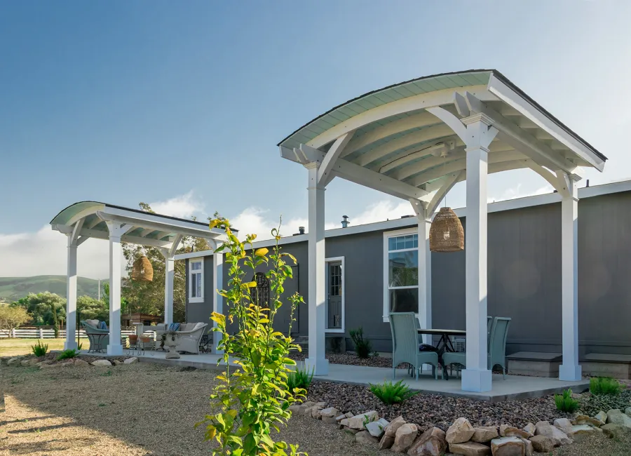  Arched Thick Timber Pavilion (Options: 12' L x 12' Arc W, Douglas-fir, 1 Electrical Wiring Trim, 4-Post Anchor Kit for Concrete, 1 Ceiling Fan Base, No Privacy Panel, No Curtain Rods, 12 ft H, Horizontal Decorative Trims on Posts, Custom Paint). Photo Courtesy of Siino Ventures of Kikrland, Washington.