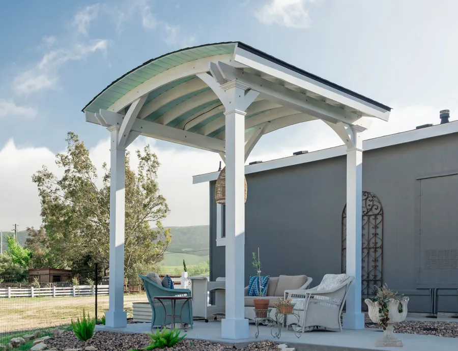  Arched Thick Timber Pavilion (Options: 12' L x 12' Arc W, Douglas-fir, 1 Electrical Wiring Trim, 4-Post Anchor Kit for Concrete, 1 Ceiling Fan Base, No Privacy Panel, No Curtain Rods, 12 ft H, Horizontal Decorative Trims on Posts, Custom Paint). Photo Courtesy of Siino Ventures of Kikrland, Washington.