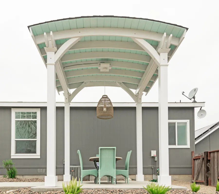  Arched Thick Timber Pavilion (Options: 12' L x 12' Arc W, Douglas-fir, 1 Electrical Wiring Trim, 4-Post Anchor Kit for Concrete, 1 Ceiling Fan Base, No Privacy Panel, No Curtain Rods, 12 ft H, Horizontal Decorative Trims on Posts, Custom Paint). Photo Courtesy of Siino Ventures of Kikrland, Washington.