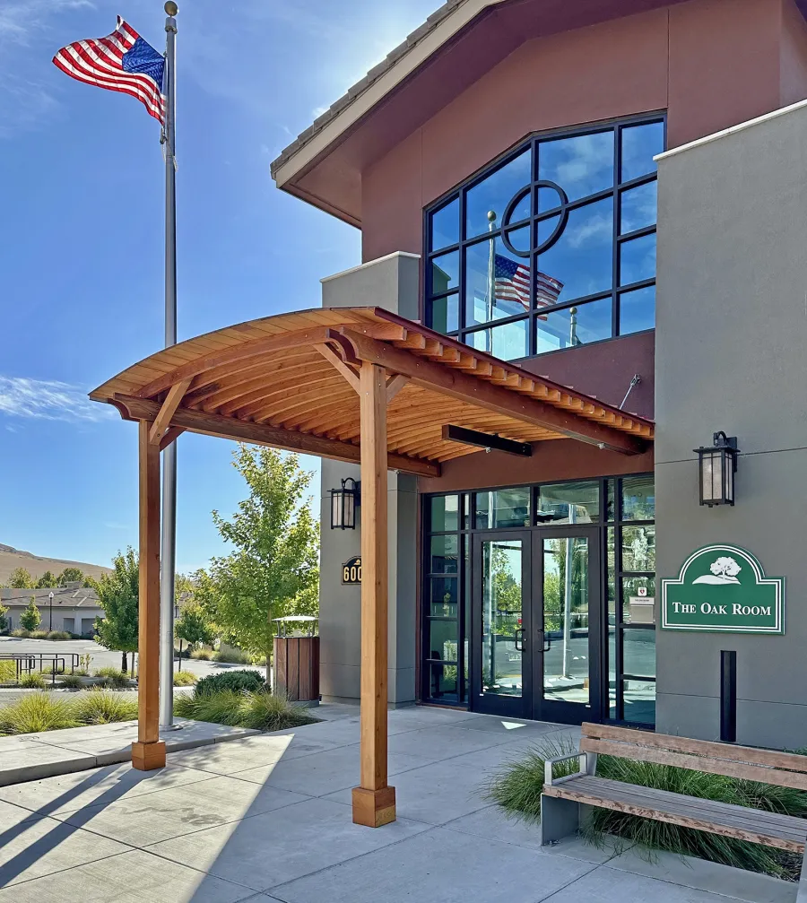 Custom  Arched Thick Timber Pavilion (Options: 10' L x 12' Arc W, Douglas-fir, 2-Post Anchor Kit for Concrete, No Ceiling Fan Base, 11'-5" H Posts, No Privacy Panel, No Curtain Rods, No Decorative Trims on Posts, Transparent Premium Sealant). Pavilion attached as an extension of an existing 5' L roof. Photo Courtesy of R. Cole of Fairfield, CA.