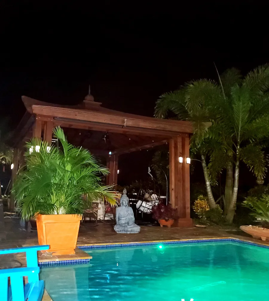 Asian Fusion Pavilion (Options: 18 ft L x 16 ft W, California Redwood, 4-Traditional Asian Fusion Anchoring Set, 1 Electrical Wiring Trim, 9.5 ft H, 1 Ceiling Fan Base, No Privacy Panels, No Curtain Rods, Cherry Stain Premium Sealant). Photo Courtesy of G. Groves Sr. of Royal Palm Beach, Florida.