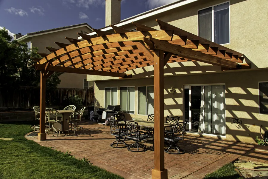 Attached Arched Pergola Kits (Options: 20' L x 15' W, California Redwood, No Electrical Wiring Trim, Arched Roof without Lattice Panels, 2-Post Anchor Kit for Concrete, No Ceiling Fan Base, No Privacy Panels, No Curtain Rods, 10' Post Height, Transparent Premium Sealant). Photo Courtesy of C. Thompson of Corona, CA.