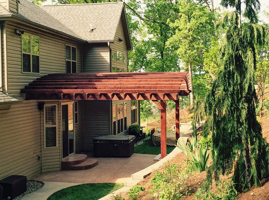Attached Arched Pergola Kits (Options: 20' L x 26' W, Douglas-fir, No Electrical Wiring Trim, Rafters at 18" and Slats at 18", Widthwise Roof Support Timbers, 2-Post Anchor Kit for Concrete, Ceiling Fan Base, No Privacy Panels, No Curtain Rods, 11' Post Height, Coffee-Stain Premium Sealant). Photo Courtesy of Susanne Stephens of Eureka, Missouri.