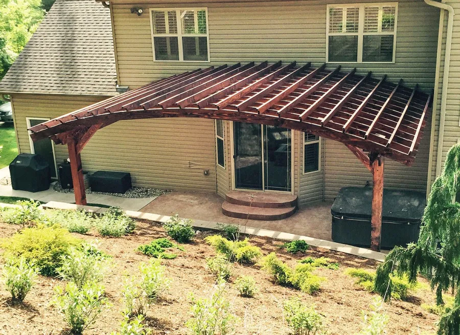 Attached Arched Pergola Kits (Options: 20' L x 26' W, Douglas-fir, No Electrical Wiring Trim, Rafters at 18" and Slats at 18", Widthwise Roof Support Timbers, 2-Post Anchor Kit for Concrete, Ceiling Fan Base, No Privacy Panels, No Curtain Rods, 11' Post Height, Coffee-Stain Premium Sealant). Photo Courtesy of Susanne Stephens of Eureka, Missouri.