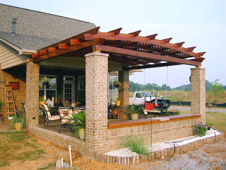Attached Arched Pergola Kits (Options: 14' L x 18' W, California Redwood, No Electrical Wiring Trim, Arched Roof with Lattice Panels, 2-Post Anchor Kit for Concrete, No Ceiling Fan Base, No Privacy Panels, No Curtain Rods, 9' Post Height,  Transparent Premium Sealant).  Posts wrapped in masonry. Photo courtesy of Mr. Brandon Campbell of  Lenoir City, Tennessee. 