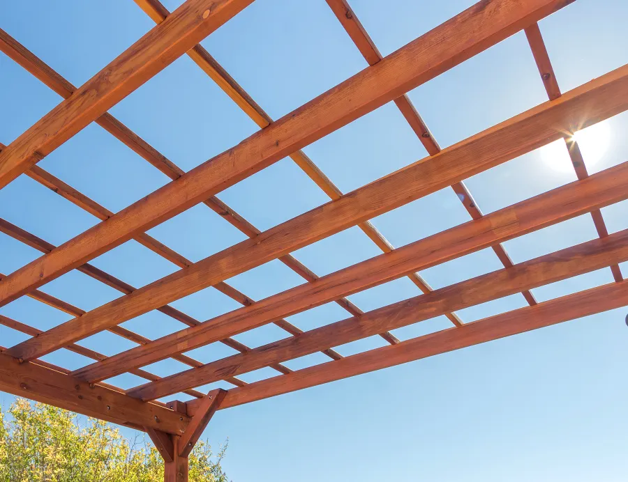 Attached Garden Perglola (Options: 12'-6" x 16', California Redwood, Open Roof with Slats at 18", Rafters at 18", Attached to the Wall by Rafter Side, 2-Post Anchor Kit for Concrete, 1 Lattice Privacy Panel, No Ceiling Fan Base, Transparent Premium Sealant). Photo Courtesy of S. Abbasi of Newbury Park, CA.