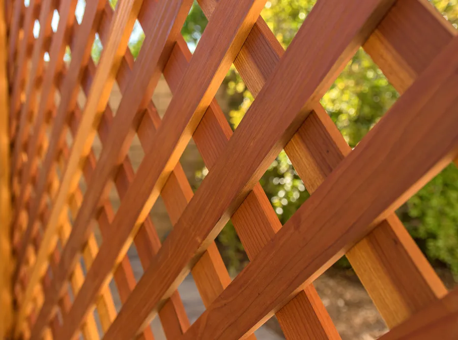 Attached Garden Perglola (Options: 12'-6" x 16', California Redwood, Open Roof with Slats at 18", Rafters at 18", Attached to the Wall by Rafter Side, 2-Post Anchor Kit for Concrete, 1 Lattice Privacy Panel, No Ceiling Fan Base, Transparent Premium Sealant). Photo Courtesy of S. Abbasi of Newbury Park, CA.