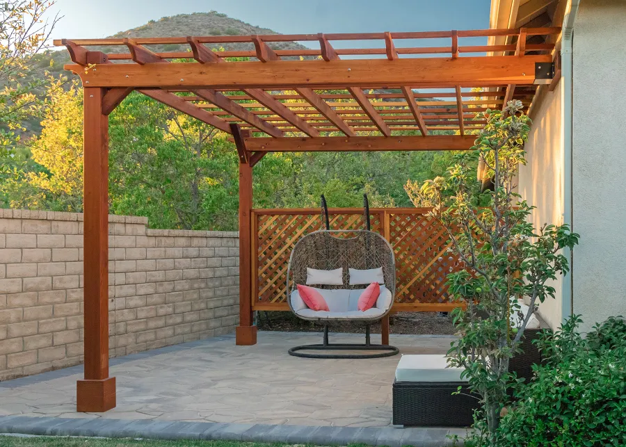 Attached Garden Perglola (Options: 12'-6" x 16', California Redwood, Open Roof with Slats at 18", Rafters at 18", Attached to the Wall by Rafter Side, 2-Post Anchor Kit for Concrete, 1 Lattice Privacy Panel, No Ceiling Fan Base, Transparent Premium Sealant). Photo Courtesy of S. Abbasi of Newbury Park, CA.