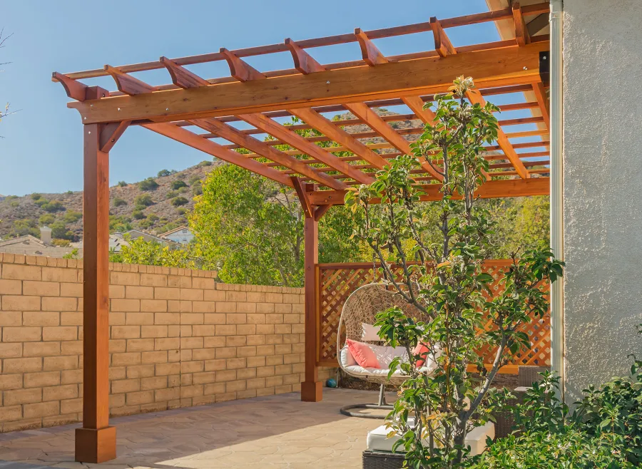 Attached Garden Perglola (Options: 12'-6" x 16', California Redwood, Open Roof with Slats at 18", Rafters at 18", Attached to the Wall by Rafter Side, 2-Post Anchor Kit for Concrete, 1 Lattice Privacy Panel, No Ceiling Fan Base, Transparent Premium Sealant). Photo Courtesy of S. Abbasi of Newbury Park, CA.