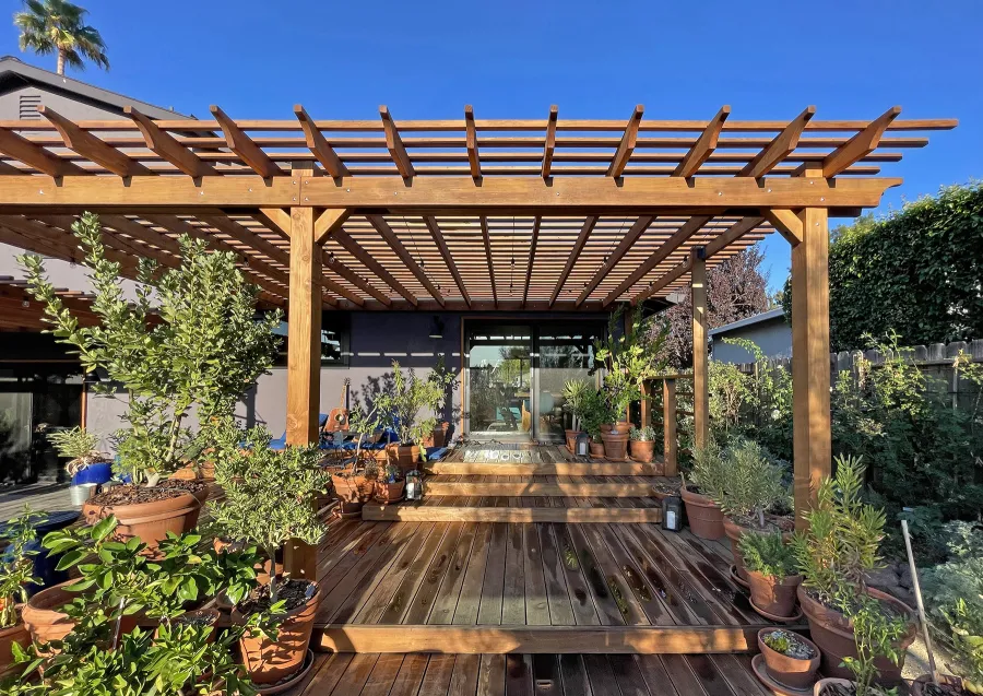 Attached Garden Pergolas (Options: 45'-6" L, One Section is 13' W and the Other Section is 15', Attached to Wall by Rafters Side, California Redwood, 1 Ceiling Fan Base, No Electrical Wiring Trim, Open Roof with Slats at 6", No Decorative Trims on Posts, 5-Post Anchor Kit for High-Wind, Transparent Premium Sealant). Photo Courtesy of D. Herman of Livermore, California.
