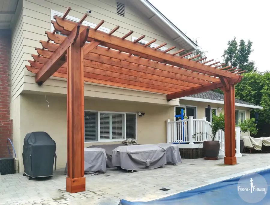 Attached Garden Pergolas (Options: 20' L x 10' W, Mature Redwood, No Electrical Wiring Trim, 2-Post Anchor Kit for High-Wind, Open Roof with Slats at 12", Rafters at 18", Vertical post decorative trim, Transparent Premium Sealant). Photo Courtesy of D. Abrams of San Jose, California.