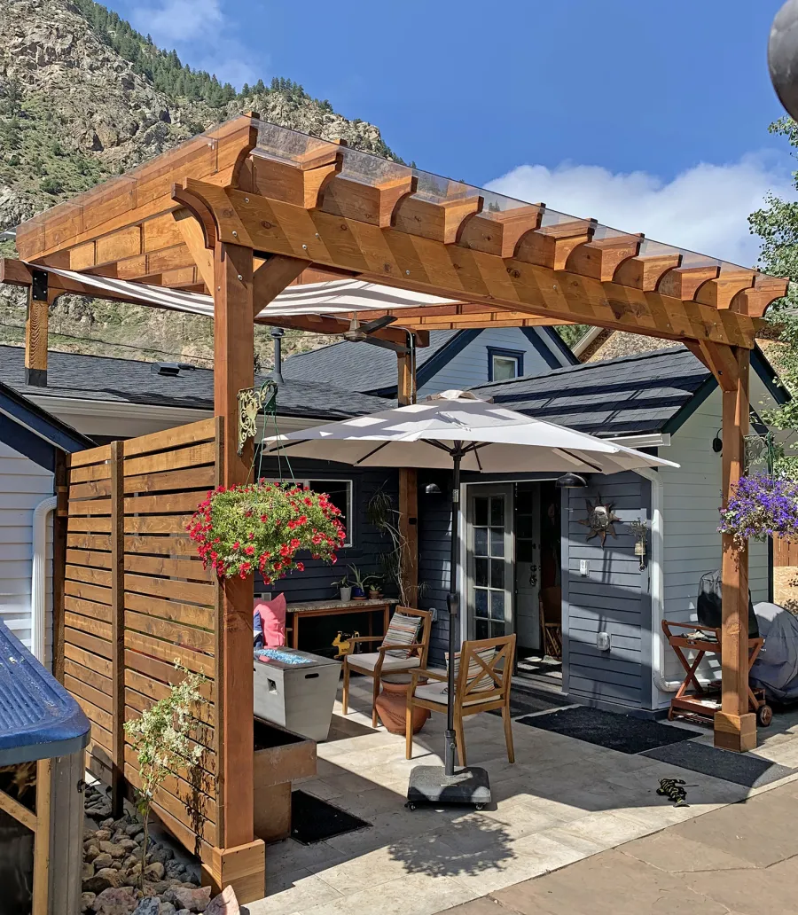 Attached Garden Perglola (Options: 16' x 16', California Redwood, Open Roof with Slats at 18", Rafters at 18", Attached to Existing Posts, with Transparent Rain Guard, 2-Post Anchor Kit for Concrete, No Privacy Panel, 1 Ceiling Fan Base, Transparent Premium Sealant). Photo Courtesy of D. Martin of Georgetown, CO.