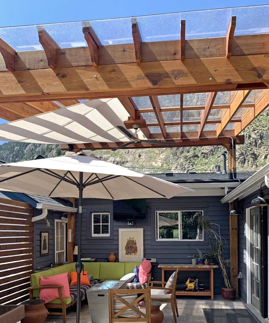 Attached Garden Perglola (Options: 16' x 16', California Redwood, Open Roof with Slats at 18", Rafters at 18", Attached to Existing Posts, with Transparent Rain Guard, 2-Post Anchor Kit for Concrete, No Privacy Panel, 1 Ceiling Fan Base, Transparent Premium Sealant). Photo Courtesy of D. Martin of Georgetown, CO.