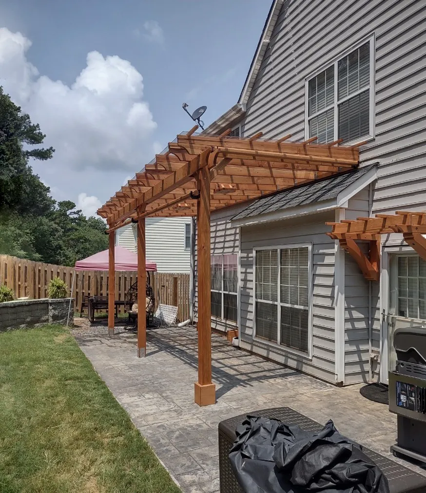 Attached Garden Pergolas (Options: 24'-6" L x 10' W, Attached to Wall by Support Side, Douglas-fir, Electrical Wiring Trim for 1 Post, 2 Ceiling Fan Bases, Open Roof with Slats at 18", with Rain Guard, 3-Post Anchor Kit for Concrete, Sloped Rafters by Custom Request, Transparent Premium Sealant).