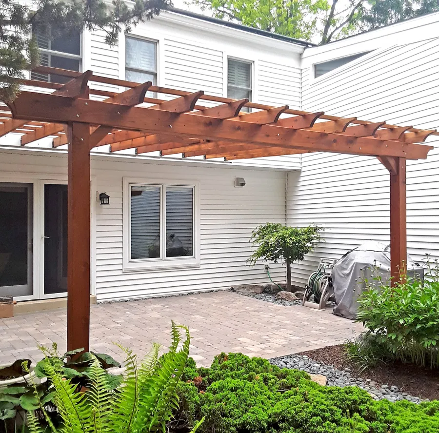 Attached Garden Pergola (Options: 18' x 15', California Redwood, Open Roof with Slats at 18", Rafters at 18", 2-Post Anchor Kit for Concrete, 1 Ceiling Fan Base, Transparent Premium Sealant). Custom framed 2' x 2' Polycarbonate Rain Guard centered atop ceiling fan base to protect fan from moisture. Photo Courtesy of M. Holland of Potomac, Maryland.