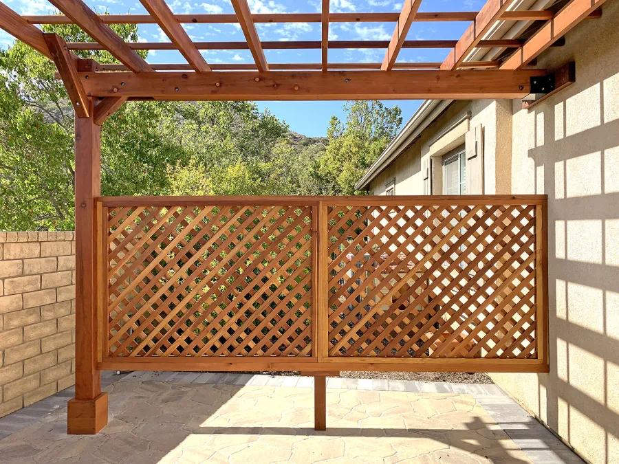 Attached Garden Perglola (Options: 12'-6" x 16', California Redwood, Open Roof with Slats at 18", Rafters at 18", Attached to the Wall by Rafter Side, 2-Post Anchor Kit for Concrete, 1 Lattice Privacy Panel, No Ceiling Fan Base, Transparent Premium Sealant). Photo Courtesy of S. Abbasi of Newbury Park, CA.