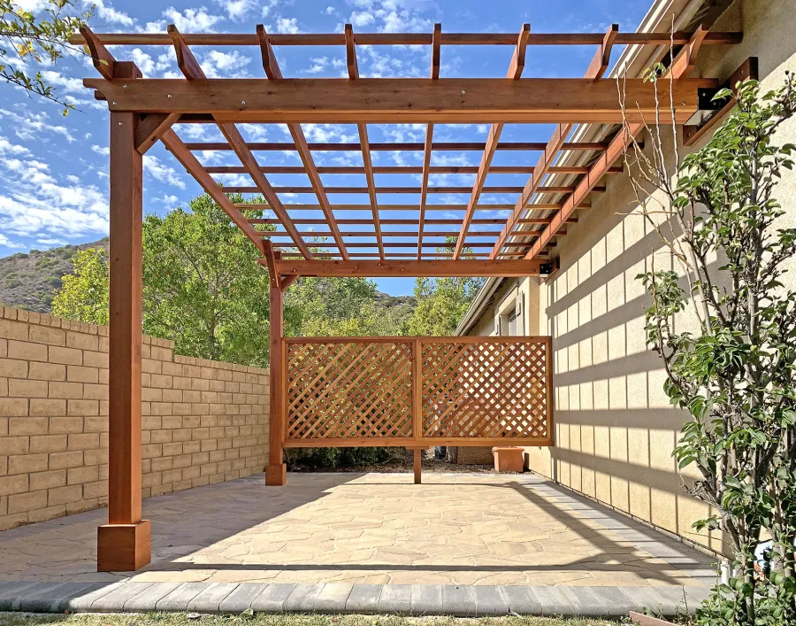 Attached Garden Perglola (Options: 12'-6" x 16', California Redwood, Open Roof with Slats at 18", Rafters at 18", Attached to the Wall by Rafter Side, 2-Post Anchor Kit for Concrete, 1 Lattice Privacy Panel, No Ceiling Fan Base, Transparent Premium Sealant). Photo Courtesy of S. Abbasi of Newbury Park, CA.