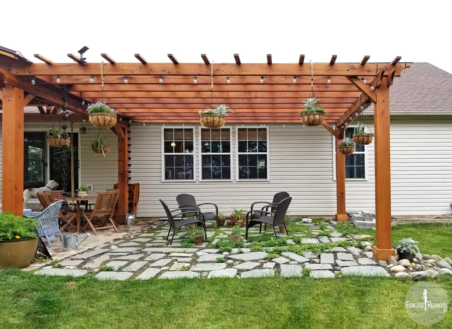 Attached Garden Pergolas (Options: 18' L x 14' W, California Redwood, No Electrical Wiring Trim, 2-Post Anchor Kit for High-Wind, Open Roof with Slats at 18", Rafters at 18", No Post Decorative Trims, Transparent Premium Sealant). Pergola Attached to a Del Norte Pavilion. Photo Courtesy of T. Lee of Noblesville, Indiana.