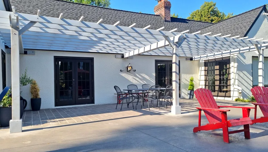 Attached Garden Pergola (Options: 32' x 14', California Redwood, Open Roof with Slats at 18", Rafters at 18", 3-Post Anchor Kit for Concrete, No Ceiling Fan Base, Gray Oil-Based Primer). Photo Courtesy of T. Elliott of Portland, Oregon.