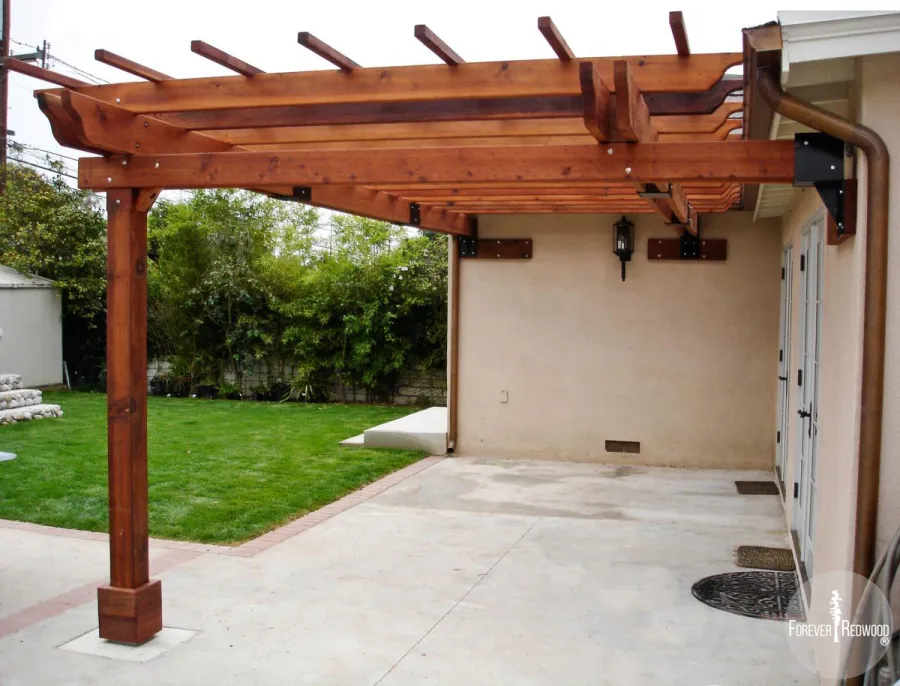 Attached Garden Pergolas (Options:10' L x 14' W, Attached to Wall by 2 Sides by Custom Request, Mature Redwood, No Electrical Wiring Trim, Open Roof with Slats at 18", 1-Post Anchor Kit for Concrete, Transparent Premium Sealant).