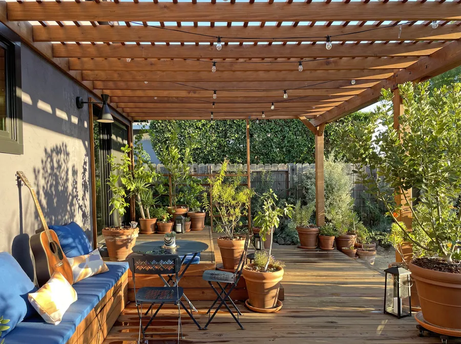 Attached Garden Pergolas (Options: 45'-6" L, One Section is 13' W and the Other Section is 15', Attached to Wall by Rafters Side, California Redwood, 1 Ceiling Fan Base, No Electrical Wiring Trim, Open Roof with Slats at 6", No Decorative Trims on Posts, 5-Post Anchor Kit for High-Wind, Transparent Premium Sealant). Photo Courtesy of D. Herman of Livermore, California.