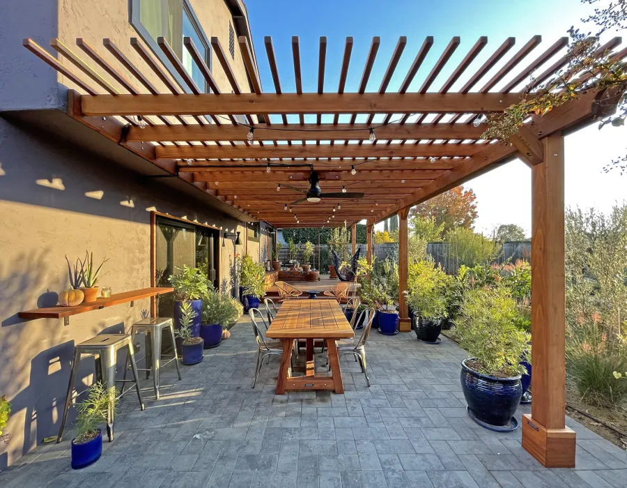 Attached Garden Pergolas (Options: 45'-6" L, One Section is 13' W and the Other Section is 15', Attached to Wall by Rafters Side, California Redwood, 1 Ceiling Fan Base, No Electrical Wiring Trim, Open Roof with Slats at 6", No Decorative Trims on Posts, 5-Post Anchor Kit for High-Wind, Transparent Premium Sealant). Photo Courtesy of D. Herman of Livermore, California.