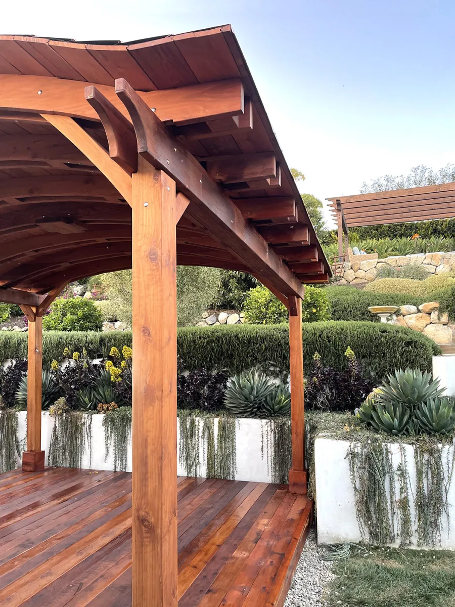 Backyard Pavilion Kit (Options: 14' L x 14-6" Arc W, Mature Redwood, 4-Post Anchor Kit for High-Wind, 1 Ceiling Fan Base, No Privacy Panels, No Electrical Wiring Trim Kit, 9.5 ft Post Height, Transparent Premium Sealant) with Deck in Mature Redwood to Match Pavilion. Copper roofing installed by custom request. Photo Courtesy of D. Goldfarb of Santa Barbara, CA.