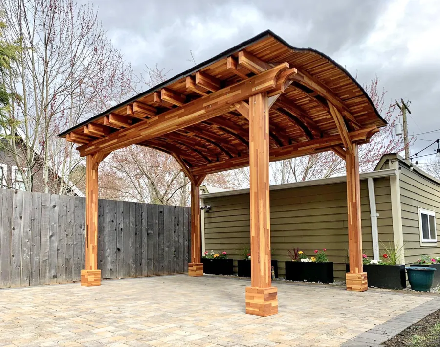 Backyard Pavilion Kits (Options: 13'-6" L x 10' Arc W, Mosaic Redwood, 4-Post Anchor Kit for High-Wind, No Ceiling Fan Base, No Privacy Panels, Electrical Wiring Trim Kit for 1 Post, 9 ft Post Height, Transparent Premium Sealant). Photo Courtesy of E. Baechler of Portland, Oregon.