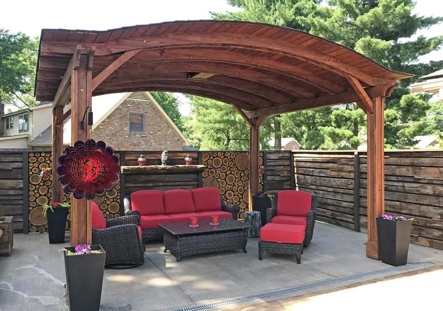 Backyard Pavilion Kits (Options: 12' L x 14' Arc W, California Redwood, 2 Post Electrical Wiring Trim, 4-Post Anchor Kit for Stone, Add Ceiling Fan Base, No Privacy Panels, No Curtain Rods, 9 ft Post Height, Coffee-Stain Premium Sealant). Photo Courtesy of Jacques & Kristi.