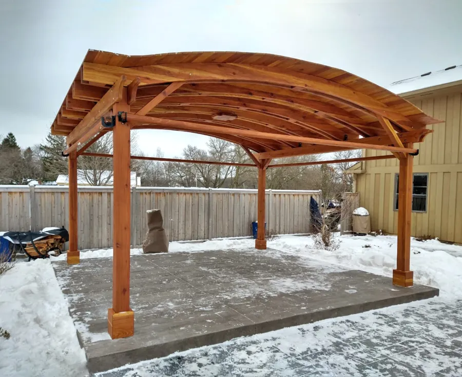Backyard Pavilion Kits (Options: 15' L x 18' Arc W, California Redwood, 2 Post Electrical Wiring Trims, 4-Post Anchor Kit for Concrete, 1 Ceiling Fan Base, No Privacy Panels, 4 Curtain Rods, 9 ft Post Height, Transparent Premium Sealant). Photo Courtesy of M. McDonald of Lake Barrington, Illinois.