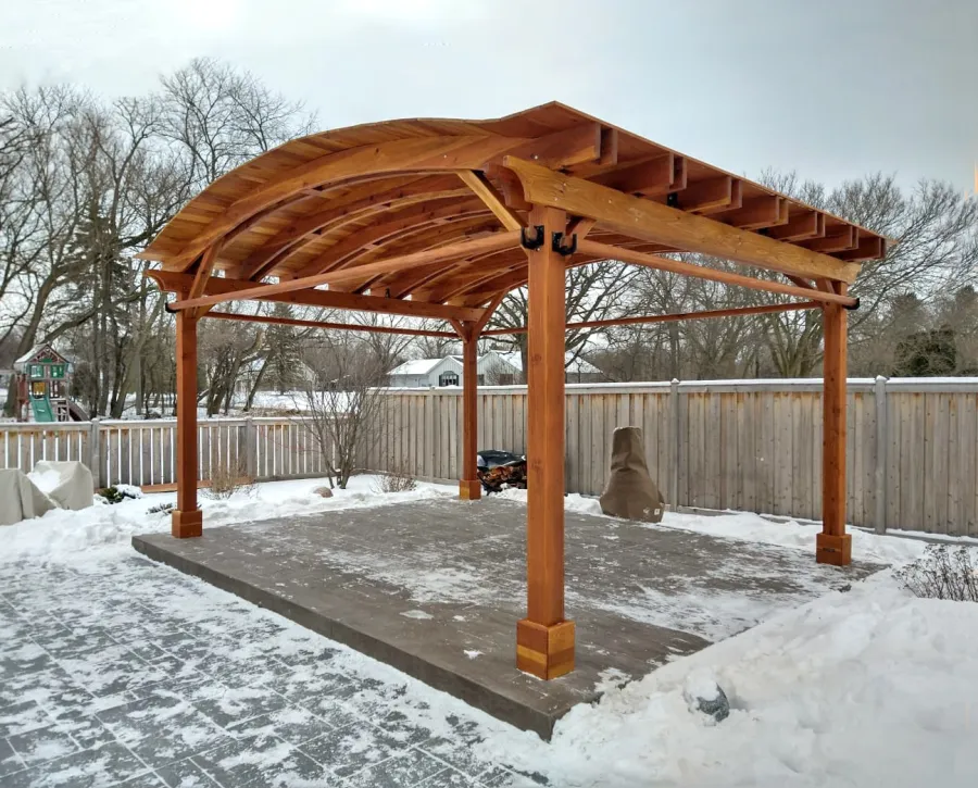 Backyard Pavilion Kits (Options: 15' L x 18' Arc W, California Redwood, 2 Post Electrical Wiring Trims, 4-Post Anchor Kit for Concrete, 1 Ceiling Fan Base, No Privacy Panels, 4 Curtain Rods, 9 ft Post Height, Transparent Premium Sealant). Photo Courtesy of M. McDonald of Lake Barrington, Illinois.