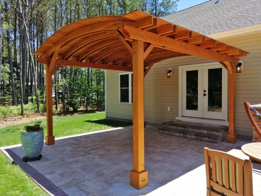 Backyard Pavilion Kits (Options: 16' L x 15' Arc W, Douglas-fir, No Post Electrical Wiring Trim, 4-Post Anchor Kit for Concrete, No Ceiling Fan Base, No Privacy Panels, No Curtain Rods, 9 ft Post Height, Transparent Premium Sealant). Photo Courtesy of S. Fly of Millsboro, Delaware.