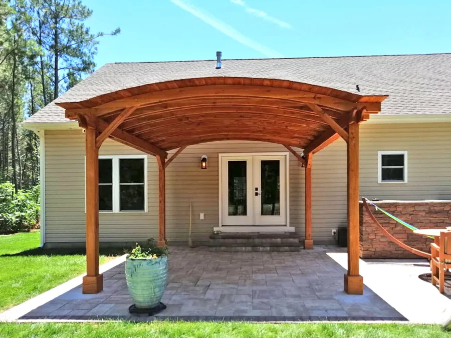 Backyard Pavilion Kits (Options: 16' L x 15' Arc W, Douglas-fir, No Post Electrical Wiring Trim, 4-Post Anchor Kit for Concrete, No Ceiling Fan Base, No Privacy Panels, No Curtain Rods, 9 ft Post Height, Transparent Premium Sealant). Photo Courtesy of S. Fly of Millsboro, Delaware.