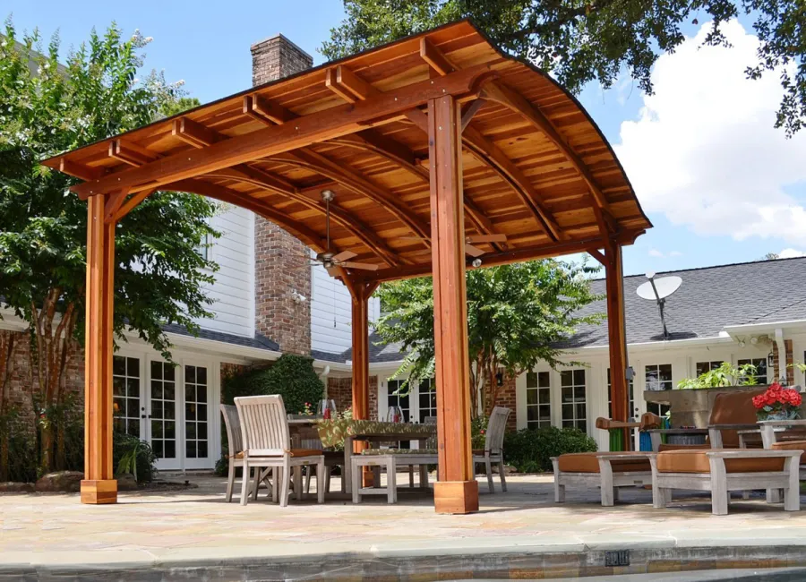 Backyard Pavilion Kits (Options: 14' L x 16' Arc W, California Redwood, 1 Post Electrical Wiring Trim, 4-Post Anchor Kit for Concrete, Add 2 Ceiling Fan Bases, No Privacy Panels, No Curtain Rods, 10 ft Post Height, Transparent Premium Sealant). Photo Courtesy of John E. Ligums of Houston, Texas.