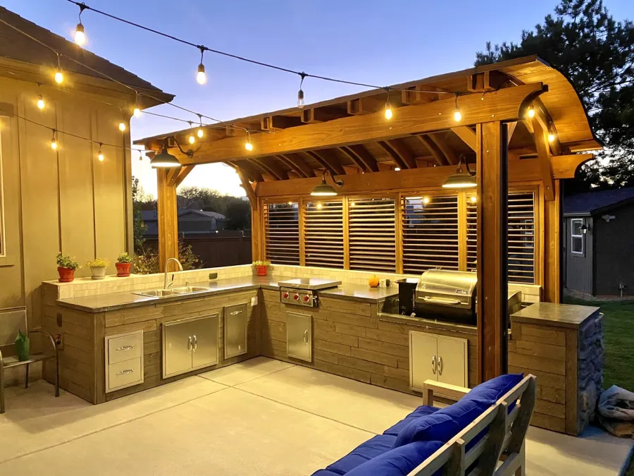 Backyard Pavilion Kits (Options: 18' x 7', California Redwood, Electrical Wiring Trim Kit for 1 Post, 4-Post Anchor Kit for Wood, No Ceiling Fan Base, 1 Privacy Panel with Louvers, No Curtain Rods, 9.5 ft Post Height, Coffee-Stain Premium Sealant). Photo Courtesy of D. Balls of Draper, Utah.