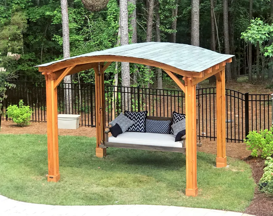 Backyard Pavilion Kits (Options: 12' L x 10' Arc W, Douglas-fir, No Electrical Wiring Trim, 4-Post Anchor Kit for High-Wind, No Ceiling Fan Base, No Privacy Panels, No Curtain Rods, 9 ft Post Height, Transparent Premium Sealant). Swing added by customer. Photo Courtesy of E. Schechtman of Wake Forest, NC.