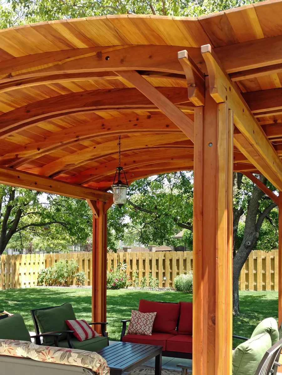 Backyard Pavilion Kits (Options: 14' L x 12' Arc W, California Redwood, No Electrical Wiring Trim, 4-Post Anchor Kit for Concrete, No Ceiling Fan Base, No Privacy Panels, No Curtain Rods, 9 ft Post Height, Transparent Premium Sealant). Photo Courtesy of B. Hardesty of Great Bend, KS.