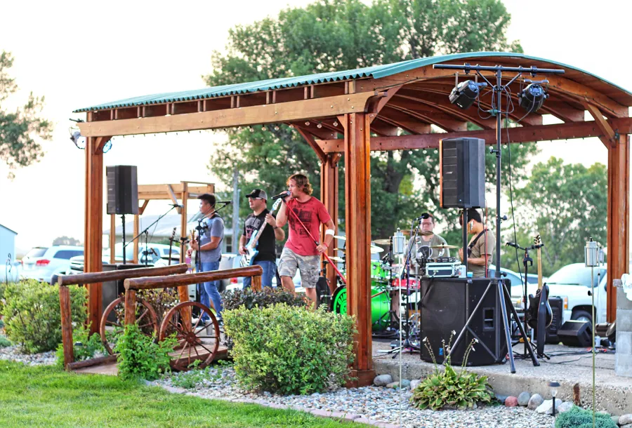 Backyard Pavilion Kits (Options: 20' x 12'-6", California Redwood, No Electrical Wiring Trim Kit, 4-Post Anchor Kit for Concrete, 1 Ceiling Fan Base, No Privacy Panels, No Curtain Rods, 10 ft Post Height, Transparent Premium Sealant). Photo Courtesy of Jody & Bob Purdie of Mitchellville, Iowa.