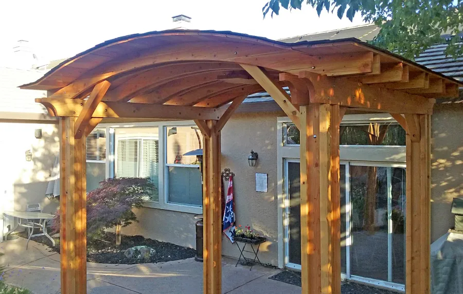 Backyard Pavilion Kits (Options: 12' L x 10' Arc W, Douglas-fir, 1 Post Electrical Wiring Trim, 4-Post Anchor Kit for Concrete, Add Ceiling Fan Base, No Privacy Panels, No Curtain Rods, 9 ft Post Height, Transparent Premium Sealant). Photo Courtesy of R. Short of Roseville, CA.