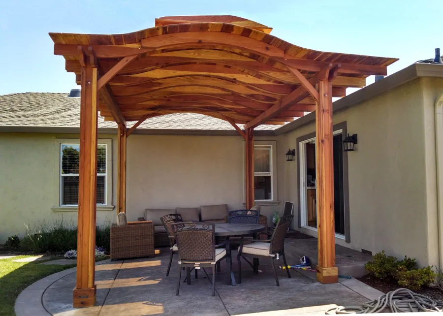 Backyard Pavilion Kits (Options: 18' x 15', California Redwood, No Electrical Wiring Trim, 4-Post Anchor Kit for Stone, No Ceiling Fan Base, No Privacy Panels, No Curtain Rods, 9.5 ft Post Height, Transparent Premium Sealant). Note: Skylights are custom add-on we can do for any size Pavilion roof. Overhang is longer on one side than other by custom request (standard overhang is 12