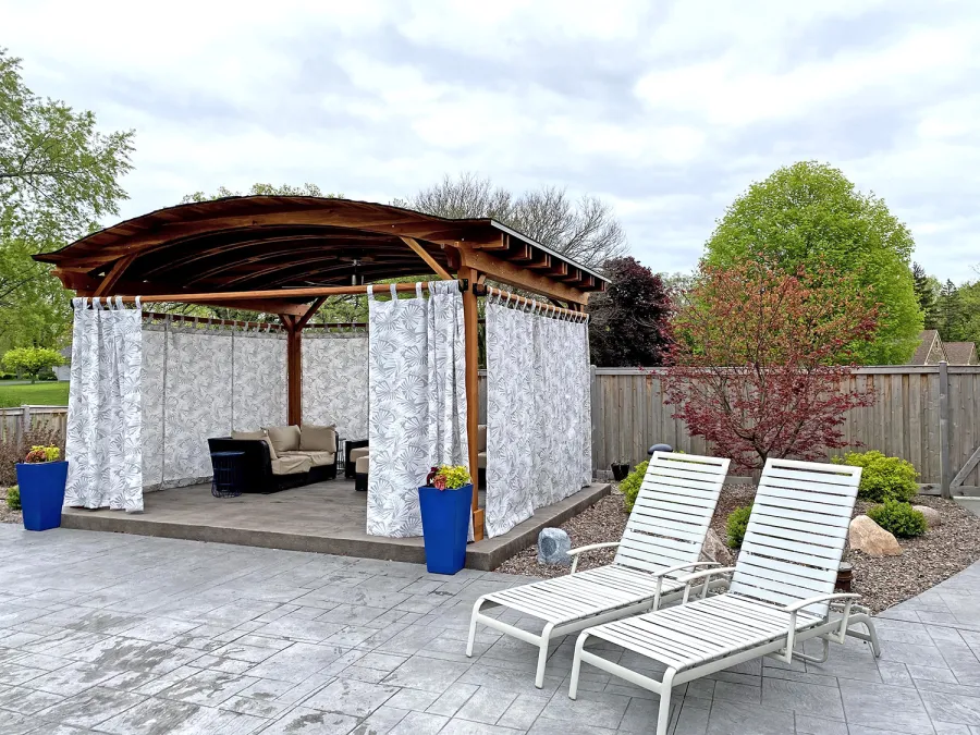 Backyard Pavilion Kits (Options: 15' L x 18' Arc W, California Redwood, 2 Post Electrical Wiring Trims, 4-Post Anchor Kit for Concrete, 1 Ceiling Fan Base, No Privacy Panels, 4 Curtain Rods, 9 ft Post Height, Transparent Premium Sealant). Photo Courtesy of S. McDonald of Lake Barrington, Illinois.